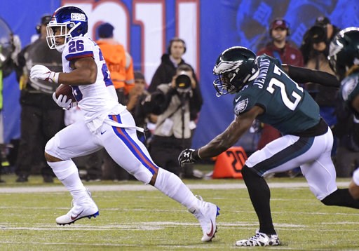 (AP Photo/Bill Kostroun). New York Giants running back Saquon Barkley (26) runs away from Philadelphia Eagles' Malcolm Jenkins (27) and Jalen Mills (31) during the first half of an NFL football game Thursday, Oct. 11, 2018, in East Rutherford, N.J. (AP Photo/Bill Kostroun). New York Giants running back Saquon Barkley (26) runs away from Philadelphia Eagles' Malcolm Jenkins (27) and Jalen Mills (31) during the first half of an NFL football game Thursday, Oct. 11, 2018, in East Rutherford, N.J.