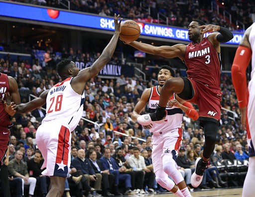 Olynyk's putback off Wade's miss lifts Heat past Wiz 113-112