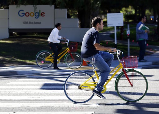 (AP Photo/Marcio Jose Sanchez, File). FILE - In this Oct. 20, 2015 file photo, employees ride company bicycles outside Google headquarters in Mountain View, Calif. Hundreds of Google employees are expected to temporality leave their jobs Thursday morni... (AP Photo/Marcio Jose Sanchez, File). FILE - In this Oct. 20, 2015 file photo, employees ride company bicycles outside Google headquarters in Mountain View, Calif. Hundreds of Google employees are expected to temporality leave their jobs Thursday morni...