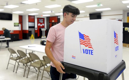 (Colleen McGrath/The Herald-Mail via AP). James Fitzgerald, of Boonsboro, Md., a poll worker for the last four months, sets up a voting booth at Northern Middle School in Hagerstown, Md., Monday, Nov. 5, 2018, on the eve of the 2018 midterm elections. (Colleen McGrath/The Herald-Mail via AP). James Fitzgerald, of Boonsboro, Md., a poll worker for the last four months, sets up a voting booth at Northern Middle School in Hagerstown, Md., Monday, Nov. 5, 2018, on the eve of the 2018 midterm elections.