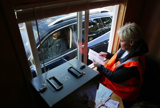 (Joe Kline/The Bulletin via AP). Deschutes County Clerk Nancy Blankenship checks for voter signatures while collecting ballots at the drive-up ballot drop site in downtown Bend, Ore., on Monday, Nov. 5, 2018. (Joe Kline/The Bulletin via AP). Deschutes County Clerk Nancy Blankenship checks for voter signatures while collecting ballots at the drive-up ballot drop site in downtown Bend, Ore., on Monday, Nov. 5, 2018.