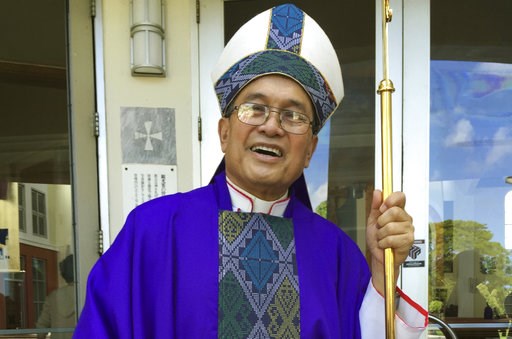 (AP Photo/Grace Garces Bordallo, File). FILE - In this November 2014 file photo, Archbishop Anthony Apuron stands in front of the Dulce Nombre de Maria Cathedral Basilica in Hagatna, Guam. Guam's Catholic church announced Wednesday, Nov. 7, 2018 that i... (AP Photo/Grace Garces Bordallo, File). FILE - In this November 2014 file photo, Archbishop Anthony Apuron stands in front of the Dulce Nombre de Maria Cathedral Basilica in Hagatna, Guam. Guam's Catholic church announced Wednesday, Nov. 7, 2018 that i...