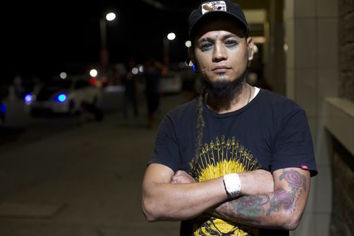 (AP Photo/Moises Castillo). In this Nov. 1, 2018 photo, Honduran migrant Braulio Bustillo, 33, poses for photo as he waits for a bus at the Metropolitan Grand Central bus terminal in San Pedro Sula, Honduras. The tattoo artist agreed to deported after ... (AP Photo/Moises Castillo). In this Nov. 1, 2018 photo, Honduran migrant Braulio Bustillo, 33, poses for photo as he waits for a bus at the Metropolitan Grand Central bus terminal in San Pedro Sula, Honduras. The tattoo artist agreed to deported after ...