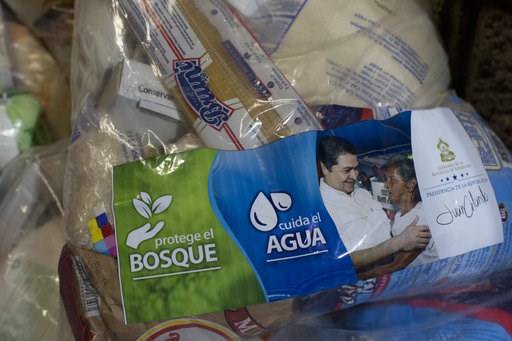 (AP Photo/Moises Castillo). This Oct. 30, 2018 photo shows "solidarity bags" of basic goods that include rice, dried spaghetti and sugar, along with a photo of President Juan Orlando Hernandez and a note saying it comes from his government, at a migran... (AP Photo/Moises Castillo). This Oct. 30, 2018 photo shows "solidarity bags" of basic goods that include rice, dried spaghetti and sugar, along with a photo of President Juan Orlando Hernandez and a note saying it comes from his government, at a migran...