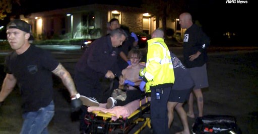 (RMG News via AP). In this image taken from video a victim is treated near the scene of a shooting, Wednesday evening, Nov. 7, 2018, in Thousand Oaks, Calif. A hooded gunman dressed entirely in black opened fire on a crowd at a country dance bar holdi... (RMG News via AP). In this image taken from video a victim is treated near the scene of a shooting, Wednesday evening, Nov. 7, 2018, in Thousand Oaks, Calif. A hooded gunman dressed entirely in black opened fire on a crowd at a country dance bar holdi...