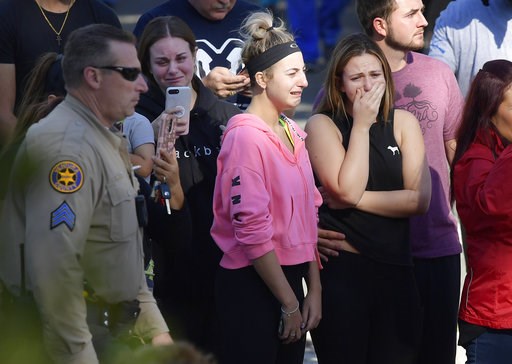 (AP Photo/Mark J. Terrill). People cry as a law enforcement motorcade escorts the body of Ventura County Sheriff's Department Sgt. Ron Helus from the Los Robles Regional Medical Center Thursday, Nov. 8, 2018, in Thousand Oaks, Calif., after a gunman op... (AP Photo/Mark J. Terrill). People cry as a law enforcement motorcade escorts the body of Ventura County Sheriff's Department Sgt. Ron Helus from the Los Robles Regional Medical Center Thursday, Nov. 8, 2018, in Thousand Oaks, Calif., after a gunman op...