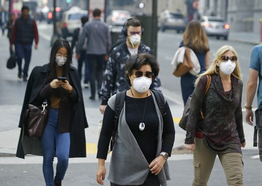 (AP Photo/Eric Risberg). People wear masks while walking through the Financial District in the smoke-filled air Friday, Nov. 9, 2018, in San Francisco. Authorities have issued an unhealthy air quality alert for parts of the San Francisco Bay Area as sm... (AP Photo/Eric Risberg). People wear masks while walking through the Financial District in the smoke-filled air Friday, Nov. 9, 2018, in San Francisco. Authorities have issued an unhealthy air quality alert for parts of the San Francisco Bay Area as sm...