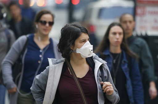 (AP Photo/Eric Risberg). A woman wears a mask while walking through the Financial District in the smoke-filled air Friday, Nov. 9, 2018, in San Francisco. Authorities have issued an unhealthy air quality alert for parts of the San Francisco Bay Area as... (AP Photo/Eric Risberg). A woman wears a mask while walking through the Financial District in the smoke-filled air Friday, Nov. 9, 2018, in San Francisco. Authorities have issued an unhealthy air quality alert for parts of the San Francisco Bay Area as...
