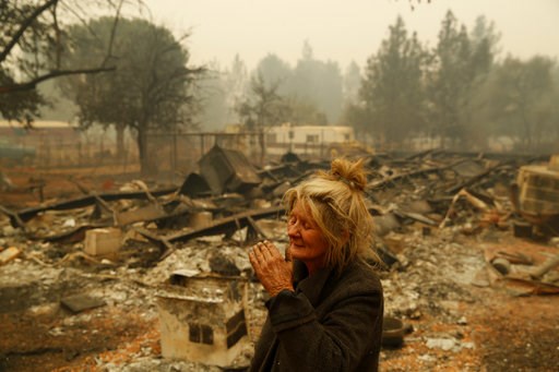 (AP Photo/John Locher). Cathy Fallon reacts as she stands near the charred remains of her home, Friday, Nov. 9, 2018, in Paradise, Calif. "I'll be darned if I'm going to let those horses burn in the fire," said Fallon, who stayed on her property to pro... (AP Photo/John Locher). Cathy Fallon reacts as she stands near the charred remains of her home, Friday, Nov. 9, 2018, in Paradise, Calif. "I'll be darned if I'm going to let those horses burn in the fire," said Fallon, who stayed on her property to pro...