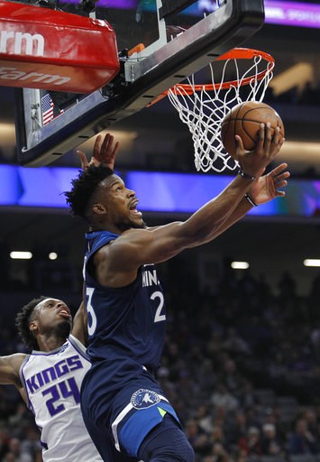 (AP Photo/Steve Yeater). Minnesota Timberwolves guard Jimmy Butler (23) gets around Sacramento Kings guard Buddy Hield (24) for a basket during the first half of an NBA basketball game in Sacramento, Calif., Friday, Nov. 9, 2018. (AP Photo/Steve Yeater). Minnesota Timberwolves guard Jimmy Butler (23) gets around Sacramento Kings guard Buddy Hield (24) for a basket during the first half of an NBA basketball game in Sacramento, Calif., Friday, Nov. 9, 2018.