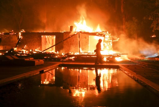 (AP Photo/Ringo H.W. Chiu). A firefighter walks by the a burning home in Malibu, Calif., Friday, Nov. 9, 2018. A Southern California wildfire continues to burn homes as it runs toward the sea. Winds are blamed for pushing the fire through scenic canyon... (AP Photo/Ringo H.W. Chiu). A firefighter walks by the a burning home in Malibu, Calif., Friday, Nov. 9, 2018. A Southern California wildfire continues to burn homes as it runs toward the sea. Winds are blamed for pushing the fire through scenic canyon...