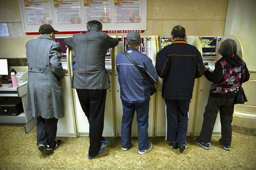 (AP Photo/Mark Schiefelbein). In this Oct. 31, 2018, photo, Chinese investors use computer terminals as they monitor stock prices at a brokerage house in Beijing. China's government is trying to dispel stock market gloom and talk prices back up with pr... (AP Photo/Mark Schiefelbein). In this Oct. 31, 2018, photo, Chinese investors use computer terminals as they monitor stock prices at a brokerage house in Beijing. China's government is trying to dispel stock market gloom and talk prices back up with pr...