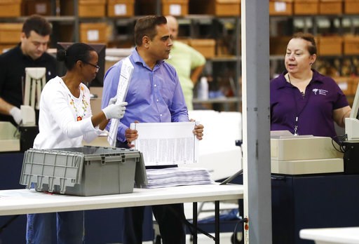 The Latest: Gov. Scott to step down from elections board