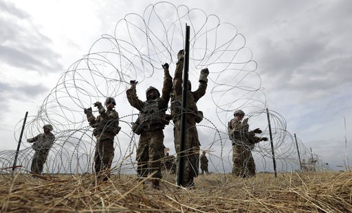 Migrants won't see armed soldiers on border