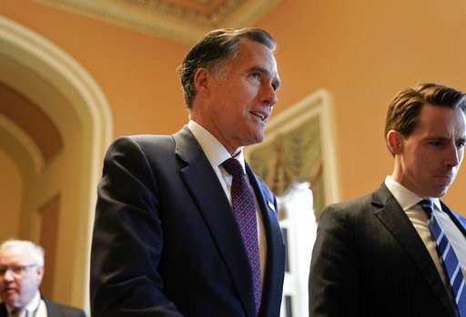 (AP Photo/Pablo Martinez Monsivais, File). FILE - In this Nov. 14, 2018, file photo, Sen.-elect Mitt Romney, R-Utah, center, walks the hallway on Capitol Hill in Washington. Romney is a man in-between. He made it to Washington after all _ but not as pr...