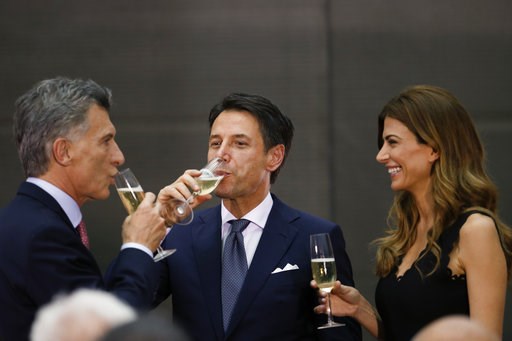 (AP Photo/Natacha Pisarenko). Argentina's President Mauricio Macri, left, and Argentina's first lady Juliana Awada, right, share a glass of champagne with Italy's Prime Minister Giuseppe Conte at the presidential palace in Buenos Aires, Argentina, Thur... (AP Photo/Natacha Pisarenko). Argentina's President Mauricio Macri, left, and Argentina's first lady Juliana Awada, right, share a glass of champagne with Italy's Prime Minister Giuseppe Conte at the presidential palace in Buenos Aires, Argentina, Thur...