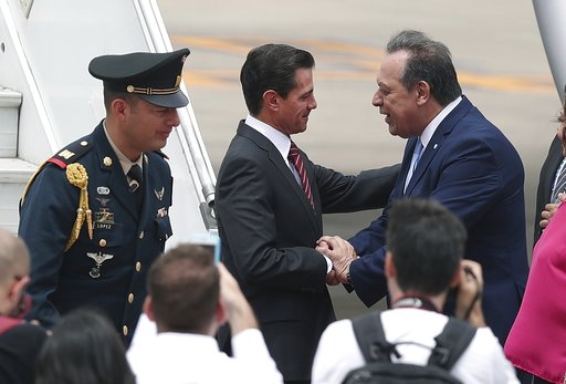 (AP Photo/Martin Mejia). Mexico's President Enrique Pena Nieto, center, is received by Argentina's Tourism Secretary, Gustavo Santos, at the Ministro Pistarini international airport in Buenos Aires, Argentina, Thursday, Nov. 29, 2018. Leaders from the ... (AP Photo/Martin Mejia). Mexico's President Enrique Pena Nieto, center, is received by Argentina's Tourism Secretary, Gustavo Santos, at the Ministro Pistarini international airport in Buenos Aires, Argentina, Thursday, Nov. 29, 2018. Leaders from the ...