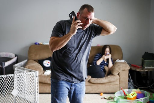 (AP Photo/John Minchillo). In this Nov. 28, 2018 photo, Tom Wolikow, a General Motors employee who is currently laid-off, left, takes a phone call at home alongside his fiance Rochelle Carlisle, right, in Warren, Ohio. It was working-class voters who b... (AP Photo/John Minchillo). In this Nov. 28, 2018 photo, Tom Wolikow, a General Motors employee who is currently laid-off, left, takes a phone call at home alongside his fiance Rochelle Carlisle, right, in Warren, Ohio. It was working-class voters who b...
