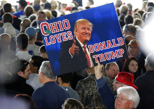 (AP Photo/Gene J. Puskar). In this March 14, 2016 photo, a supporter of Republican presidential candidate Donald Trump holds a sign during a plane-side rally at Youngstown-Warren Regional Airport in Vienna, Ohio. It was working-class voters who bucked ... (AP Photo/Gene J. Puskar). In this March 14, 2016 photo, a supporter of Republican presidential candidate Donald Trump holds a sign during a plane-side rally at Youngstown-Warren Regional Airport in Vienna, Ohio. It was working-class voters who bucked ...