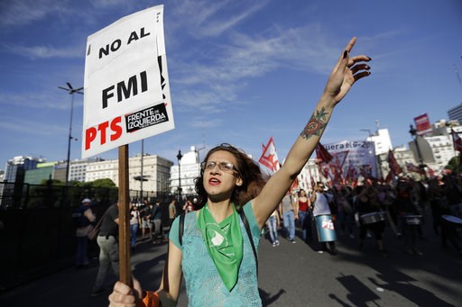 (AP Photo/Natacha Pisarenko). A protester carries a poster reading in Spanish "No to the IMF" during a march against the G20 summit being held in Buenos Aires, Argentina, Friday, Nov. 30, 2018. Leaders from the Group of 20 industrialized nations are me... (AP Photo/Natacha Pisarenko). A protester carries a poster reading in Spanish "No to the IMF" during a march against the G20 summit being held in Buenos Aires, Argentina, Friday, Nov. 30, 2018. Leaders from the Group of 20 industrialized nations are me...