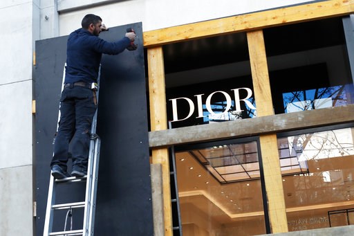 (AP Photo/Thibault Camus). A worker reinforces a shop window on the Champs Elysees avenue, in Paris, Friday, Nov. 30, 2018. Workers were barricading shop windows along Paris' famed Champs-Elysees Avenue on Friday, a day before a protest against governm... (AP Photo/Thibault Camus). A worker reinforces a shop window on the Champs Elysees avenue, in Paris, Friday, Nov. 30, 2018. Workers were barricading shop windows along Paris' famed Champs-Elysees Avenue on Friday, a day before a protest against governm...