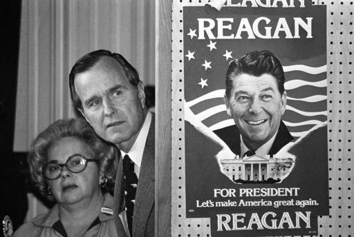 (AP Photo, File). FILE - In this March 4, 1980 file photo, George H.W. Bush and an unidentified woman peek around a partition with a poster of Ronald Reagan, one of his opponents for the Republican party presidential nomination, before he speaks in Col... (AP Photo, File). FILE - In this March 4, 1980 file photo, George H.W. Bush and an unidentified woman peek around a partition with a poster of Ronald Reagan, one of his opponents for the Republican party presidential nomination, before he speaks in Col...