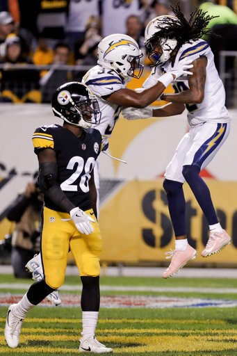 (AP Photo/Gene J. Puskar). Los Angeles Chargers wide receiver Travis Benjamin (12) celebrates with running back Justin Jackson (32) after scoring a touchdown past Pittsburgh Steelers cornerback Mike Hilton (28) in the first half of an NFL football game... (AP Photo/Gene J. Puskar). Los Angeles Chargers wide receiver Travis Benjamin (12) celebrates with running back Justin Jackson (32) after scoring a touchdown past Pittsburgh Steelers cornerback Mike Hilton (28) in the first half of an NFL football game...