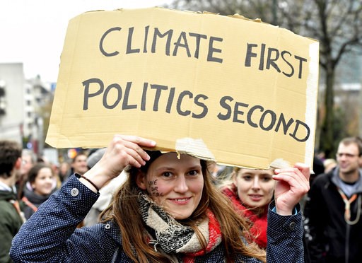(AP Photo/Geert Vanden Wijngaert). A demonstrator holds a placard which reads 'climate first, politics second' during a 'Claim the Climate' march in Brussels, Sunday, Dec. 2, 2018. The climate change conference, COP24, will take place in Poland from De... (AP Photo/Geert Vanden Wijngaert). A demonstrator holds a placard which reads 'climate first, politics second' during a 'Claim the Climate' march in Brussels, Sunday, Dec. 2, 2018. The climate change conference, COP24, will take place in Poland from De...