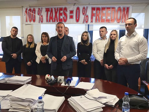 (AP Photo/Florent Bajrami). Kosovo Serb MP's stand in protest as they refuse to leave the Kosovo parliament building to protest against the 100 percent tax imposed on all goods imported from Serbia, in Pristina, Sunday Dec. 2, 2018. The group said the... (AP Photo/Florent Bajrami). Kosovo Serb MP's stand in protest as they refuse to leave the Kosovo parliament building to protest against the 100 percent tax imposed on all goods imported from Serbia, in Pristina, Sunday Dec. 2, 2018. The group said the...