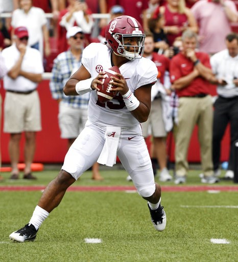 (AP Photo/Michael Woods, File). FILE - In this Oct. 6, 2018, file photo, Alabama quarterback Tua Tagovailoa rolls out before throwing a touchdown pass on the first play of the game against Arkansas in the first half of an NCAA college football game, in... (AP Photo/Michael Woods, File). FILE - In this Oct. 6, 2018, file photo, Alabama quarterback Tua Tagovailoa rolls out before throwing a touchdown pass on the first play of the game against Arkansas in the first half of an NCAA college football game, in...