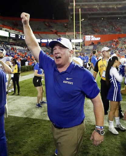 (AP Photo/John Raoux, File). FILE - In this Sept. 8, 2018, file photo, Kentucky head coach Mark Stoops celebrates with fans after defeating Florida 27-16 in an NCAA college football game, in Gainesville, Fla. Stoops is the coach of the year on The Asso... (AP Photo/John Raoux, File). FILE - In this Sept. 8, 2018, file photo, Kentucky head coach Mark Stoops celebrates with fans after defeating Florida 27-16 in an NCAA college football game, in Gainesville, Fla. Stoops is the coach of the year on The Asso...