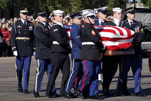 (AP Photo/David J. Phillip, Pool). The flag-draped casket of former President George H.W. Bush is carried by a joint services military honor guard to Special Air Mission 41 at Ellington Field during a departure ceremony Monday, Dec. 3, 2018, in Houston. (AP Photo/David J. Phillip, Pool). The flag-draped casket of former President George H.W. Bush is carried by a joint services military honor guard to Special Air Mission 41 at Ellington Field during a departure ceremony Monday, Dec. 3, 2018, in Houston.