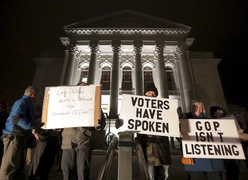 (John Hart/Wisconsin State Journal via AP). Opponents of an extraordinary session bill submitted by Wisconsin Republican legislators gather for a rally outside the Wisconsin state Capitol in Madison, Wis., Monday, Dec. 3, 2018. (John Hart/Wisconsin State Journal via AP). Opponents of an extraordinary session bill submitted by Wisconsin Republican legislators gather for a rally outside the Wisconsin state Capitol in Madison, Wis., Monday, Dec. 3, 2018.
