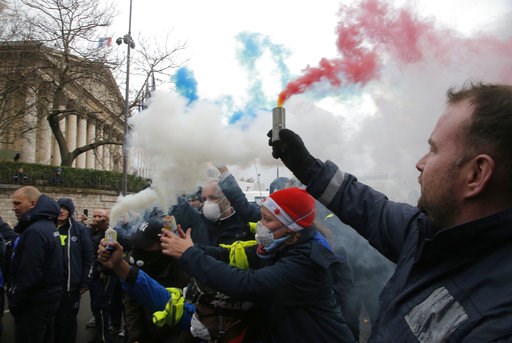 (AP Photo/Michel Euler). Ambulance workers hold flares outside the National Assembly in Paris, Monday, Dec. 3, 2018. Ambulance workers took to the streets and gathered close to the National Assembly in downtown Paris to complain about changes to workin... (AP Photo/Michel Euler). Ambulance workers hold flares outside the National Assembly in Paris, Monday, Dec. 3, 2018. Ambulance workers took to the streets and gathered close to the National Assembly in downtown Paris to complain about changes to workin...