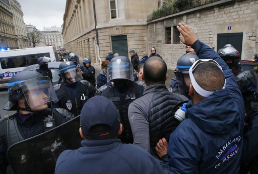 (AP Photo/Michel Euler). Ambulance workers face riot police officers outside the National Assembly in Paris, Monday, Dec. 3, 2018. Ambulance workers took to the streets and gathered close to the National Assembly in downtown Paris to complain about cha... (AP Photo/Michel Euler). Ambulance workers face riot police officers outside the National Assembly in Paris, Monday, Dec. 3, 2018. Ambulance workers took to the streets and gathered close to the National Assembly in downtown Paris to complain about cha...