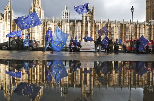(AP Photo/Frank Augstein). Protestors are reflected in a puddle as they wave European flags to demonstrate against Brexit in front of the Parliament in London, Monday, Dec. 3, 2018. (AP Photo/Frank Augstein). Protestors are reflected in a puddle as they wave European flags to demonstrate against Brexit in front of the Parliament in London, Monday, Dec. 3, 2018.