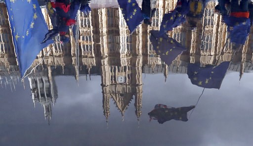(AP Photo/Frank Augstein). Protestors are reflected in a puddle as they wave European flags to demonstrate against Brexit in front of the Parliament in London, Monday, Dec. 3, 2018. (AP Photo/Frank Augstein). Protestors are reflected in a puddle as they wave European flags to demonstrate against Brexit in front of the Parliament in London, Monday, Dec. 3, 2018.