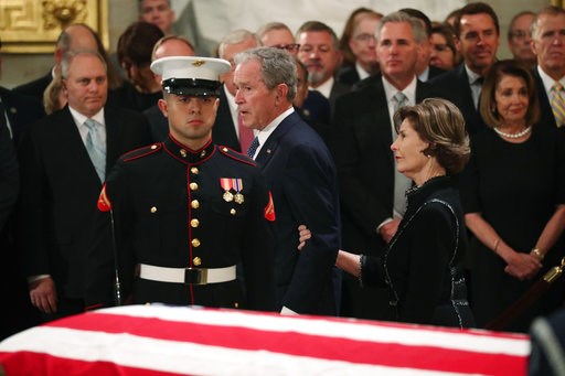 (Jonathan Ernst/Pool Photo via AP). Former President George W. Bush, with his wife former first lady Laura, walks past the casket of his father, former President George H.W. Bush at the Capitol in Washington, Monday, Dec. 3, 2018. (Jonathan Ernst/Pool Photo via AP). Former President George W. Bush, with his wife former first lady Laura, walks past the casket of his father, former President George H.W. Bush at the Capitol in Washington, Monday, Dec. 3, 2018.