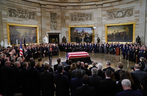 (AP Photo/Pablo Martinez Monsivais/Pool). The flag-draped casket of former President George H.W. Bush lies in state in the Capitol Rotunda in Washington, Monday, Dec. 3, 2018. (AP Photo/Pablo Martinez Monsivais/Pool). The flag-draped casket of former President George H.W. Bush lies in state in the Capitol Rotunda in Washington, Monday, Dec. 3, 2018.
