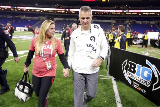 (AP Photo/Michael Conroy). Ohio State head coach Urban Meyer walks off the field with his wife, Shelley Meyer, early Sunday, Dec. 2, 2018, after defeating Northwestern in the Big Ten championship NCAA college football game in Indianapolis. Ohio State w... (AP Photo/Michael Conroy). Ohio State head coach Urban Meyer walks off the field with his wife, Shelley Meyer, early Sunday, Dec. 2, 2018, after defeating Northwestern in the Big Ten championship NCAA college football game in Indianapolis. Ohio State w...