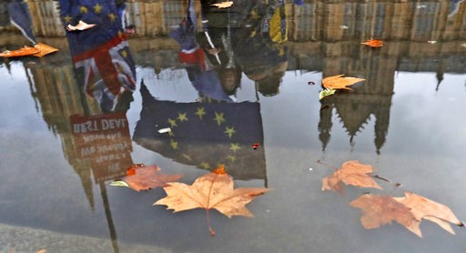 (AP Photo/Frank Augstein). Protestors are reflected in a puddle as they wave European flags to demonstrate against Brexit in front of the Parliament in London, Monday, Dec. 3, 2018. (AP Photo/Frank Augstein). Protestors are reflected in a puddle as they wave European flags to demonstrate against Brexit in front of the Parliament in London, Monday, Dec. 3, 2018.