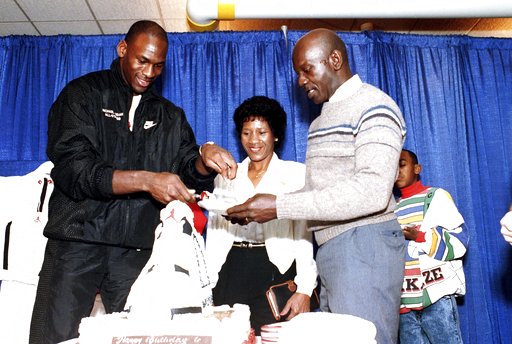 (AP Photo/Charles Bennett, File). FILE- In this Feb. 17, 1989 file photo, Chicago Bulls' Michael Jordan serves his father, James, a slice of birthday cake as his mother, Doloris, watches during a party in honor of Jordan's 26th birthday in Chicago, Ill... (AP Photo/Charles Bennett, File). FILE- In this Feb. 17, 1989 file photo, Chicago Bulls' Michael Jordan serves his father, James, a slice of birthday cake as his mother, Doloris, watches during a party in honor of Jordan's 26th birthday in Chicago, Ill...