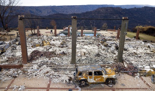 (AP Photo/Noah Berger). A vehicle rests in front of a home leveled by the Camp Fire in Paradise, Calif., on Monday, Dec. 3, 2018. (AP Photo/Noah Berger). A vehicle rests in front of a home leveled by the Camp Fire in Paradise, Calif., on Monday, Dec. 3, 2018.