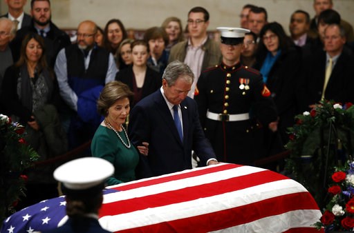 (AP Photo/Patrick Semansky). Former President George W. Bush and former first lady Laura Bush pause in front of the flag-draped casket of former President George H.W. Bush as he lies in state in the Capitol's Rotunda in Washington, Tuesday, Dec. 4, 2018. (AP Photo/Patrick Semansky). Former President George W. Bush and former first lady Laura Bush pause in front of the flag-draped casket of former President George H.W. Bush as he lies in state in the Capitol's Rotunda in Washington, Tuesday, Dec. 4, 2018.