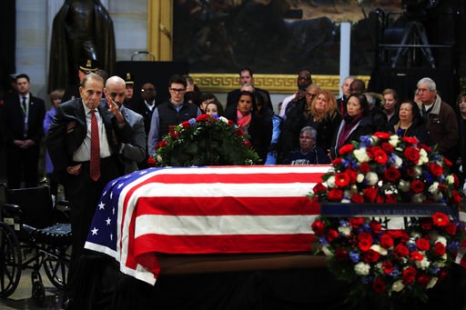(AP Photo/Manuel Balce Ceneta). Former Sen. Bob Dole salutes the flag-draped casket containing the remains of former President George H.W. Bush as he lies in state at the U.S. Capitol in Washington, Tuesday, Dec. 4, 2018. (AP Photo/Manuel Balce Ceneta). Former Sen. Bob Dole salutes the flag-draped casket containing the remains of former President George H.W. Bush as he lies in state at the U.S. Capitol in Washington, Tuesday, Dec. 4, 2018.