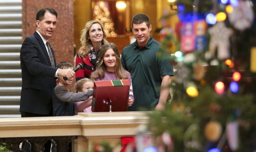 (Steve Apps/Wisconsin State Journal via AP). Wisconsin Gov. Scott Walker, left, with the help of the Mary and Don Miller family from Plainfield, Wis., flipped the switch to light the state Christmas Tree in the Capitol Rotunda, Tuesday, Dec. 4, 2018 at... (Steve Apps/Wisconsin State Journal via AP). Wisconsin Gov. Scott Walker, left, with the help of the Mary and Don Miller family from Plainfield, Wis., flipped the switch to light the state Christmas Tree in the Capitol Rotunda, Tuesday, Dec. 4, 2018 at...