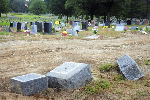 (Ned Gerard/Hearst Connecticut Media via AP, File). FILE - In this Oct. 2, 2018 file photo, toppled headstones rest on the ground in Park Cemetery in Bridgeport, Conn. A mass desecration of graves at the Connecticut cemetery has devastated dozens of fa... (Ned Gerard/Hearst Connecticut Media via AP, File). FILE - In this Oct. 2, 2018 file photo, toppled headstones rest on the ground in Park Cemetery in Bridgeport, Conn. A mass desecration of graves at the Connecticut cemetery has devastated dozens of fa...