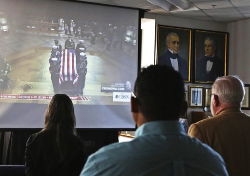 (Jacob Ford/Odessa American via AP). Attendees to George H.W. Bush's funeral viewing at the Presidential Museum and Leadership Library in Odessa, Texas, look on as a military honor guard delivers Bush's casket to the Washington National Cathedral in Wa... (Jacob Ford/Odessa American via AP). Attendees to George H.W. Bush's funeral viewing at the Presidential Museum and Leadership Library in Odessa, Texas, look on as a military honor guard delivers Bush's casket to the Washington National Cathedral in Wa...