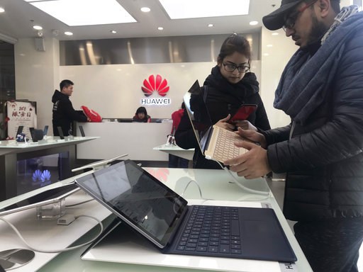 (AP Photo/Ng Han Guan). Foreigners look at a Huawei computer at a Huawei store in Beijing, China, Thursday, Dec. 6, 2018. Canadian authorities said Wednesday that they have arrested the chief financial officer of China's Huawei Technologies for possibl... (AP Photo/Ng Han Guan). Foreigners look at a Huawei computer at a Huawei store in Beijing, China, Thursday, Dec. 6, 2018. Canadian authorities said Wednesday that they have arrested the chief financial officer of China's Huawei Technologies for possibl...