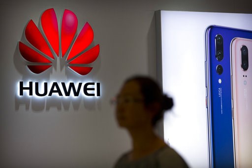 (AP Photo/Mark Schiefelbein, File). FILE - In this July 4, 2018, file photo, a shopper walks past a Huawei store at a shopping mall in Beijing. Canadian authorities said Wednesday, Dec. 5, 2018, that they have arrested the chief financial officer of C... (AP Photo/Mark Schiefelbein, File). FILE - In this July 4, 2018, file photo, a shopper walks past a Huawei store at a shopping mall in Beijing. Canadian authorities said Wednesday, Dec. 5, 2018, that they have arrested the chief financial officer of C...